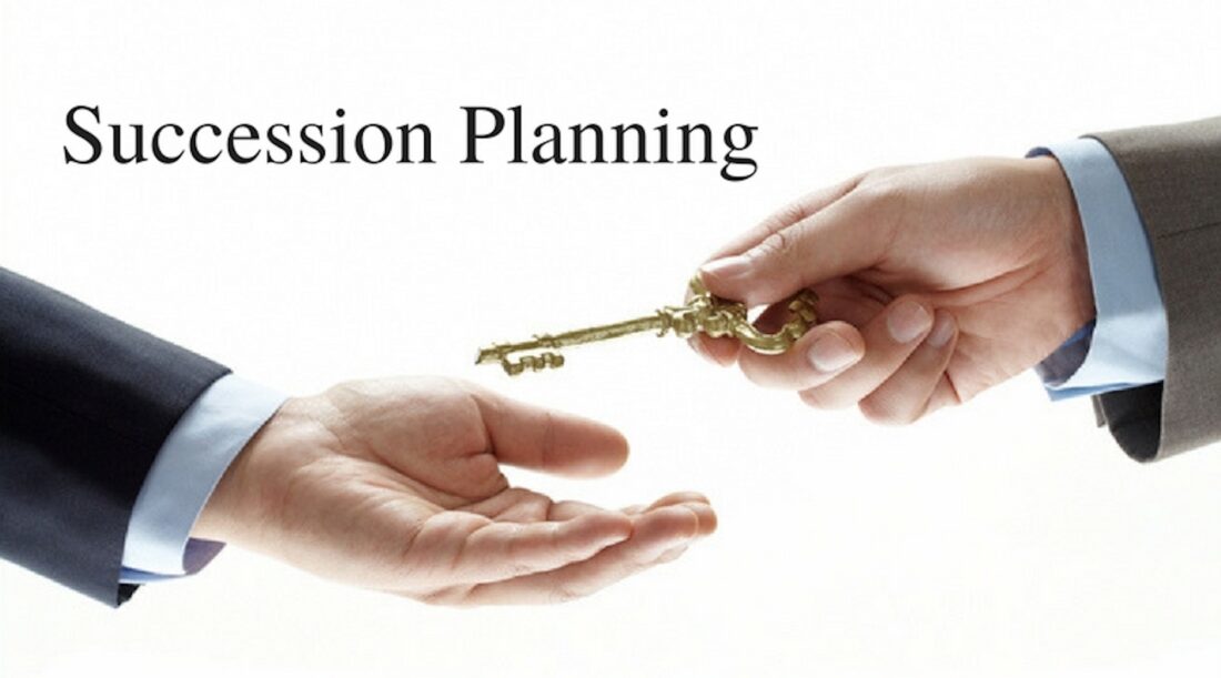 Business succession planning concept: one hand passing a key to another, symbolizing a leadership handoff