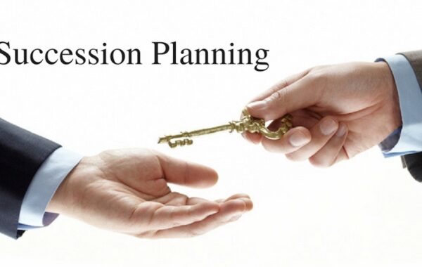 Business succession planning concept: one hand passing a key to another, symbolizing a leadership handoff