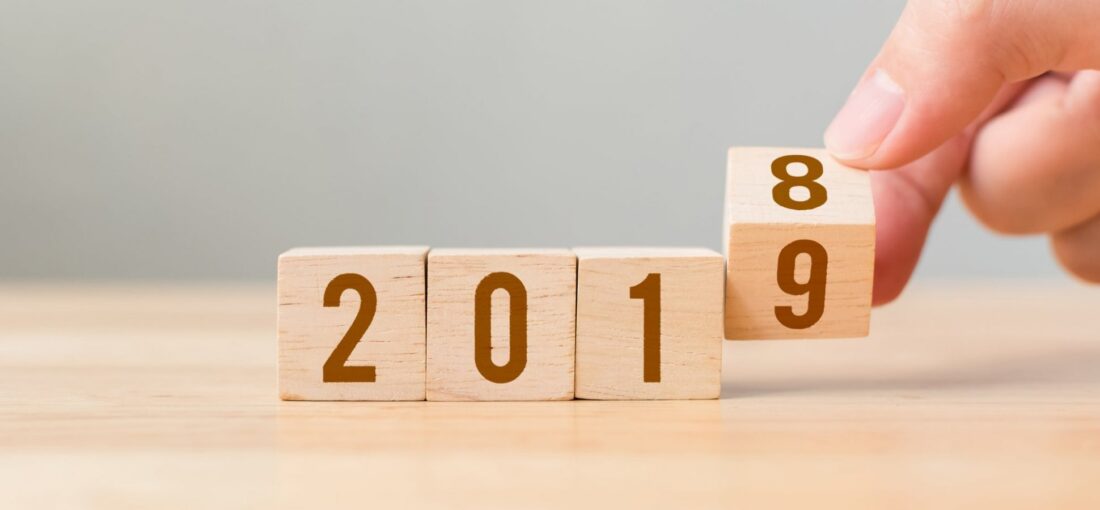 Wooden calendar blocks flipping from 2018 to 2019, representing new year business goal setting