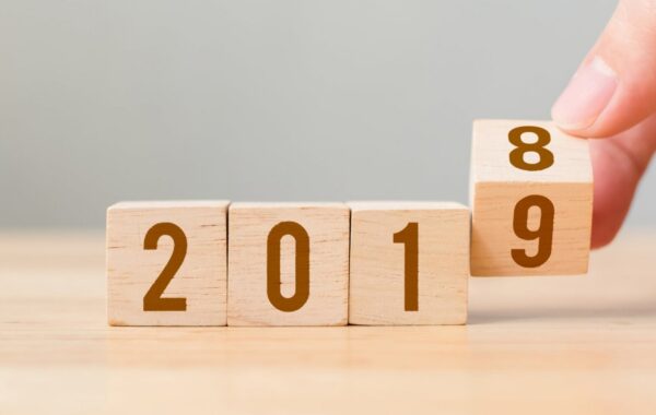 Wooden calendar blocks flipping from 2018 to 2019, representing new year business goal setting